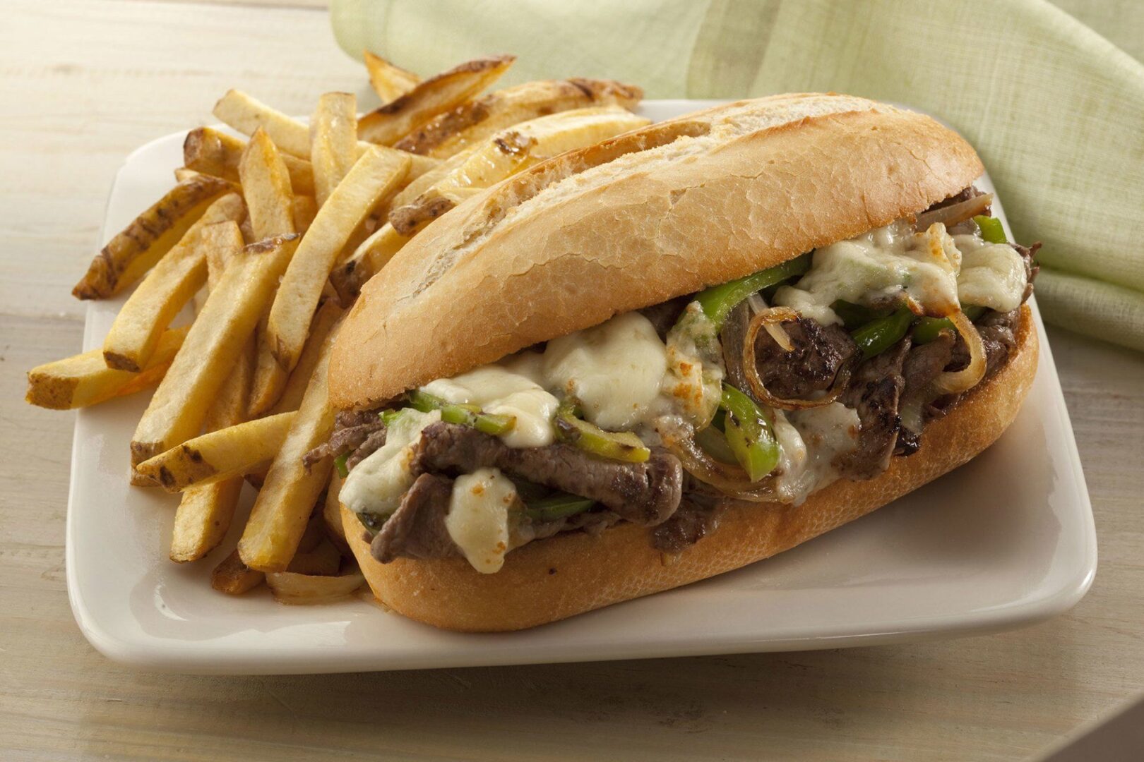 A sandwich and french fries on a plate.